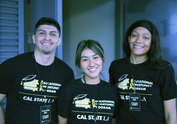 Three students smiling wearing Educational Opportunity Program t-shirts