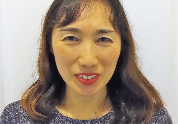 Portrait picture of a professor smiling.