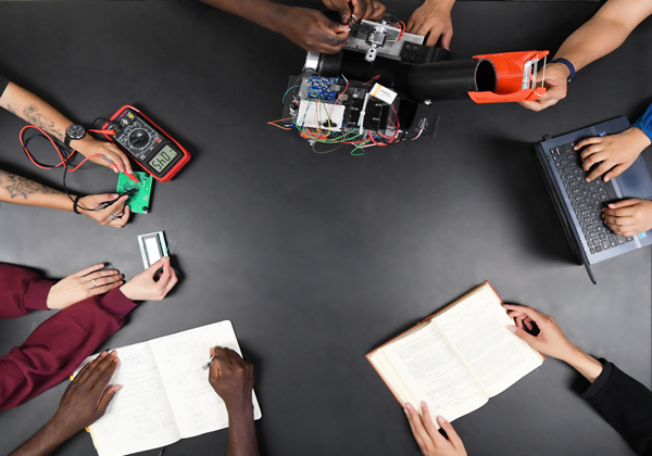 students on showing holding tools electronics