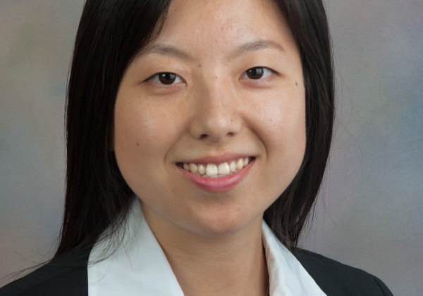 Portrait of a black hair woman smiling.