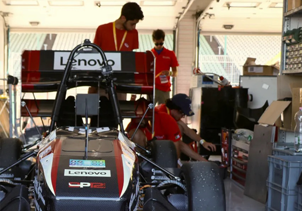 race car with people working behind it in matching polos