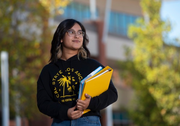 cal state LA student carrying 2 books 