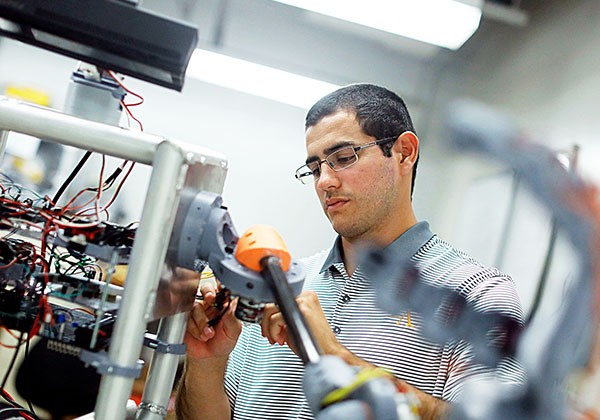 Sal Rojas working on a robot