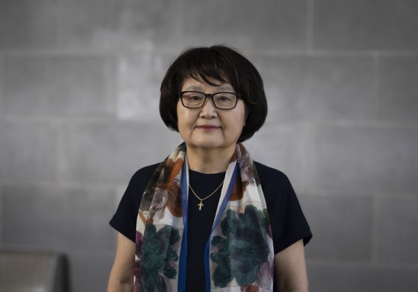 Dr. Siyon Rhee photographed in a room standing up