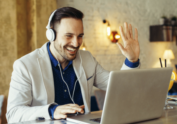 Male videochatting and waving