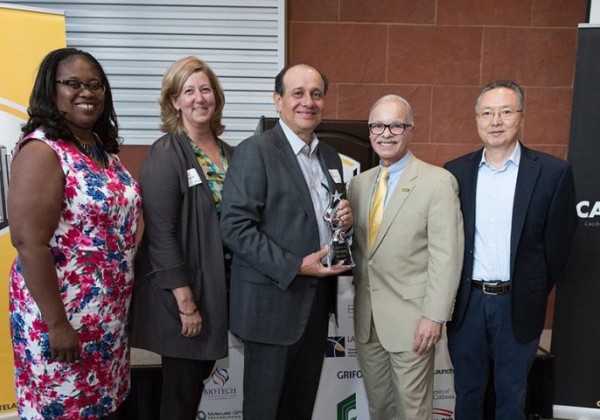 biotech leader, willie zuniga, poses for a group photo