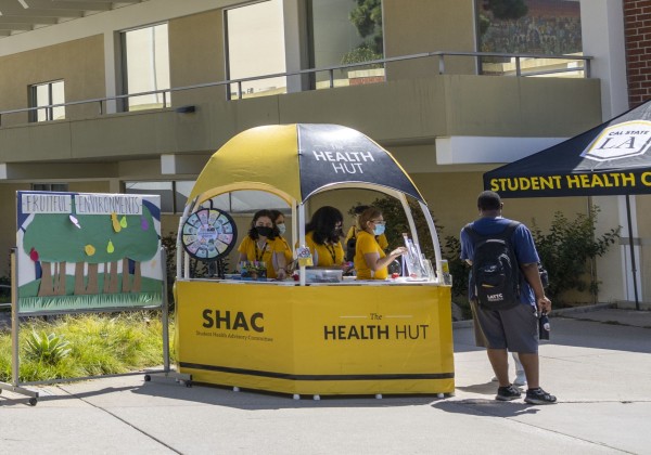 Students staffing a dome-shaped hut.