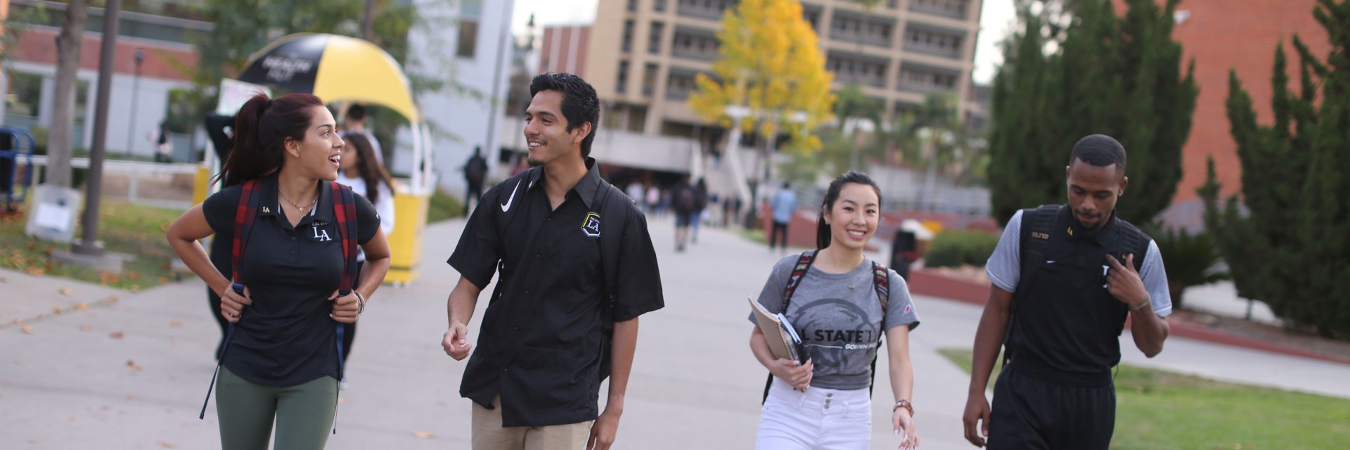 Four students walking on campus