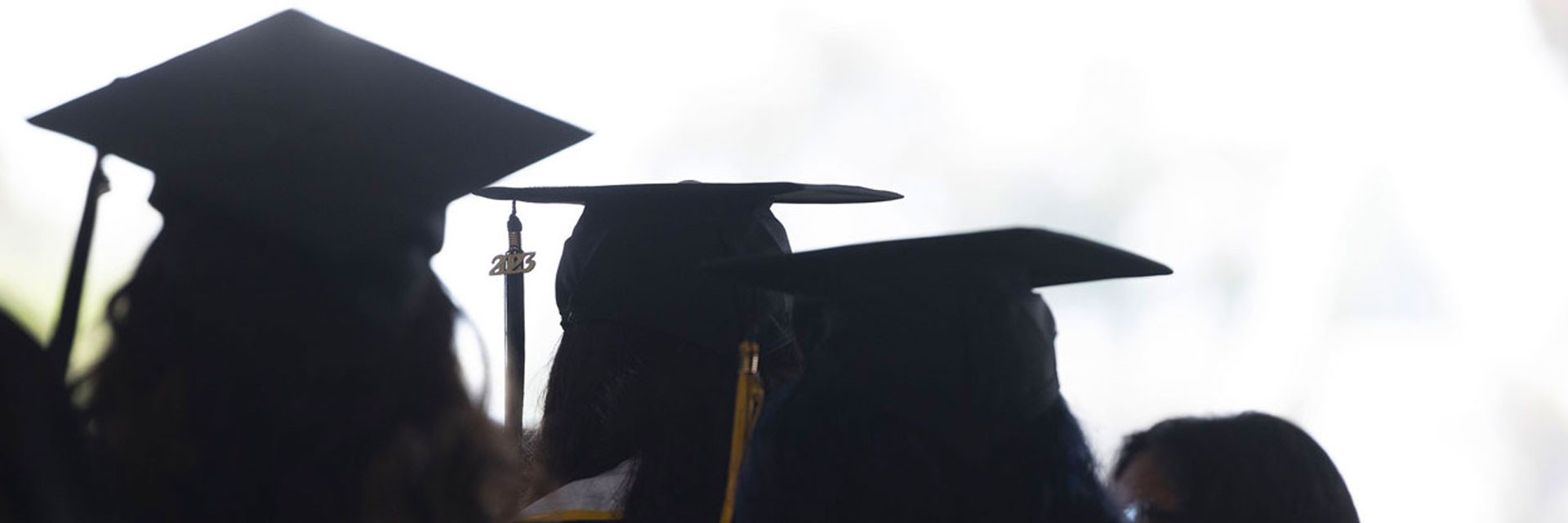 Graduates walking in a row.