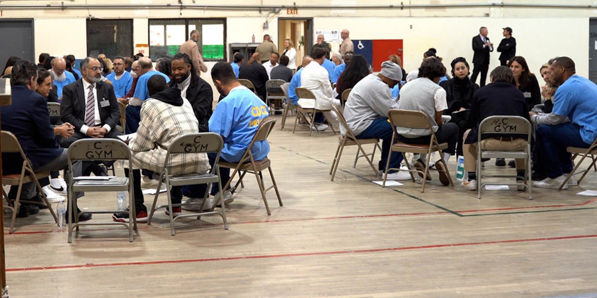 University members engaging with men in prison during an activity at the prison.