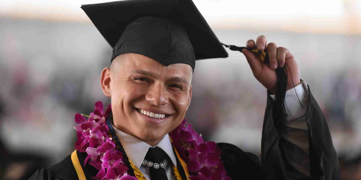 Male graduate wearing cap and gown.