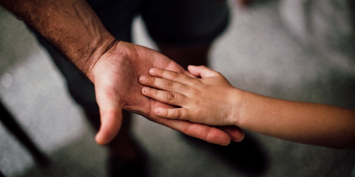 Father and son holding hands