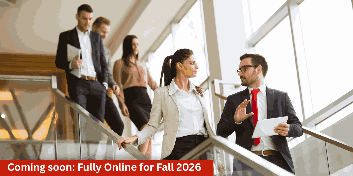 People in office building descending escalator talking to each other.