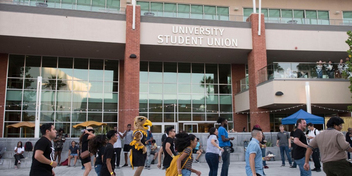 Photo of the front of the University-Student Union with people walking by