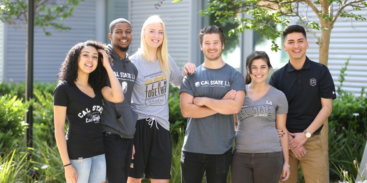 A group of students standing next to each other wearing Cal State LA branded clothing