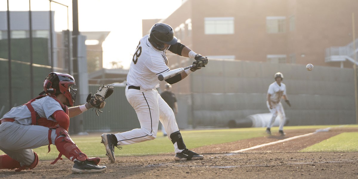 A batter hitting the baseball.