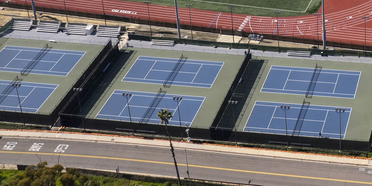 An aerial view of tennis courts on a sunny day.