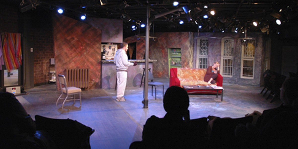 People performing a play in front of an audience.