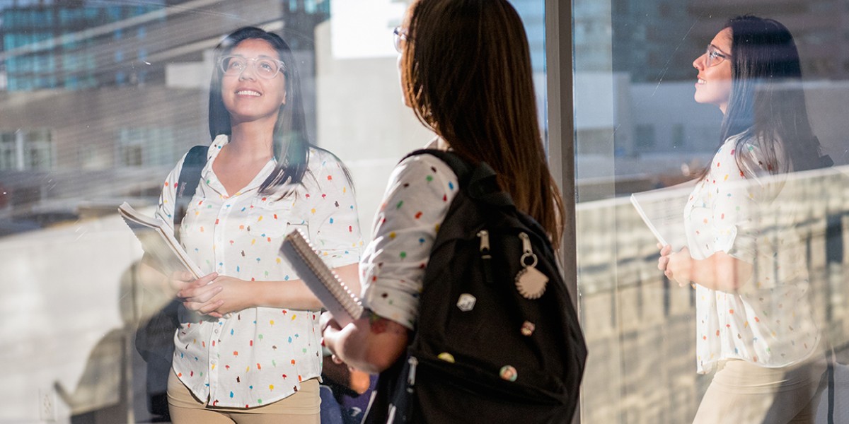 Female Student looking out a window.