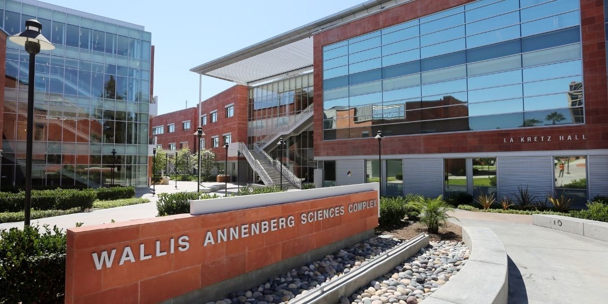 buildings with windows in background. Brick with lettering states "Wallis Annenberg Science Complex"