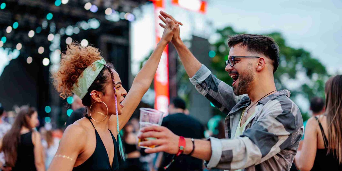 Two people dancing at an outdoor concert