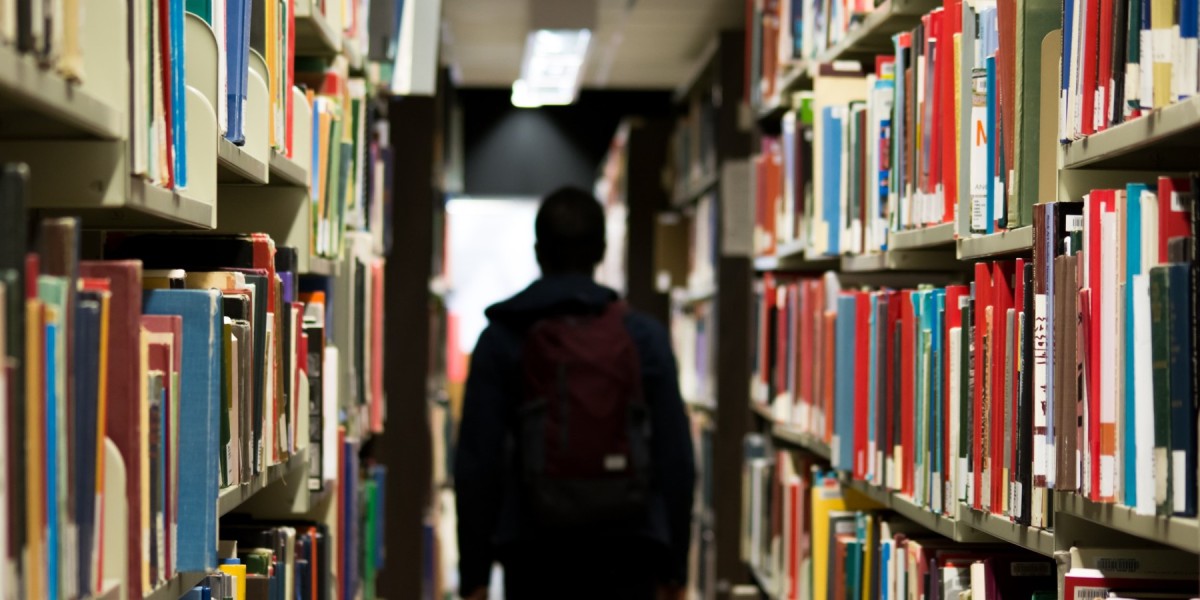 student walking through library