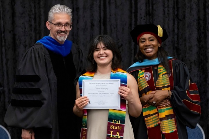 Dean of College of Education with student accepting certificate