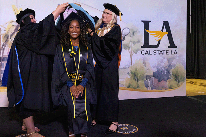 Student being hooded at Commencement Ceremony
