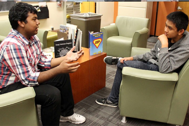 two EEp students engaged in conversation in lounge area.