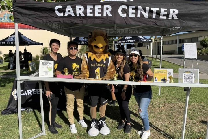 Career Center Staff smile with Eddie outside of the Career Center