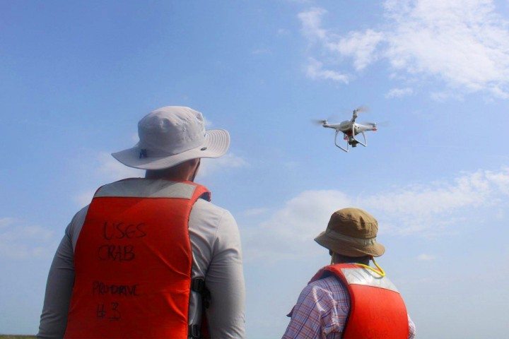 Two students flying a drone