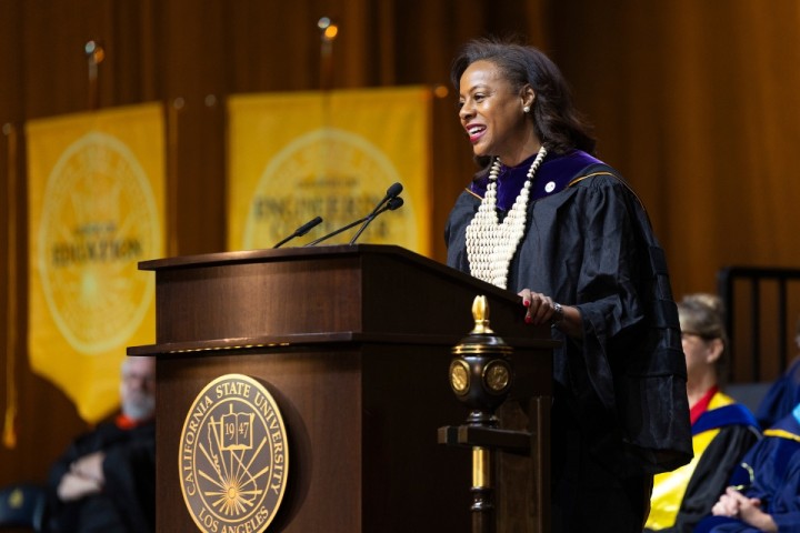 Capri Maddox speaks from behind a podium.