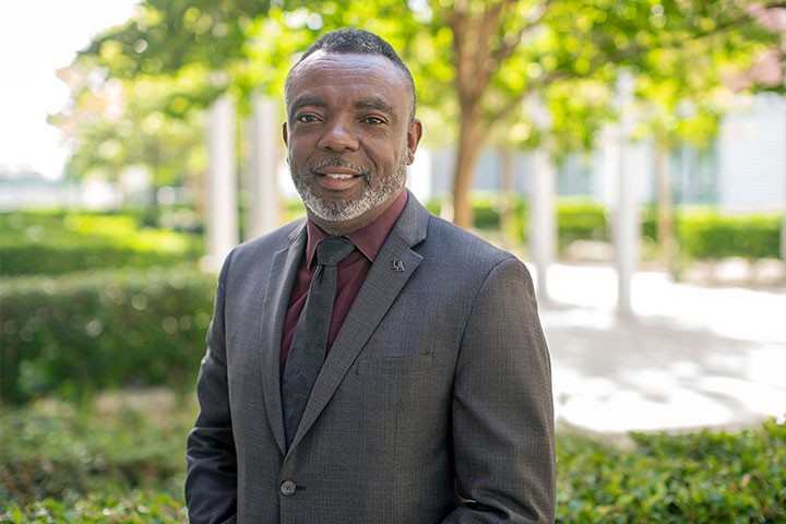 Chief Bohannon in a suit outdoors on campus