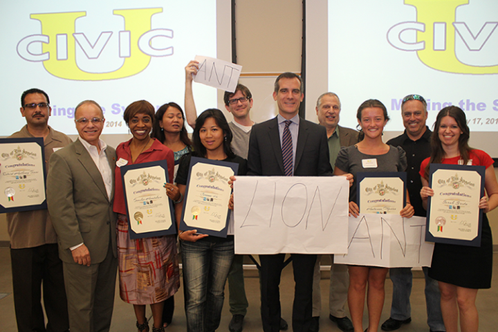 Cal State L.A. President William A. Covino and Los Angeles Mayor Eric Garcetti present certificates to students who completed Civic University.