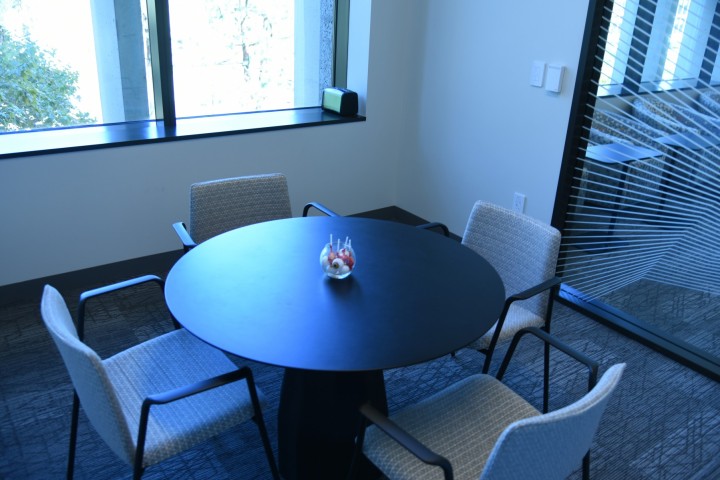 Room with a window and a small round table with four chairs.