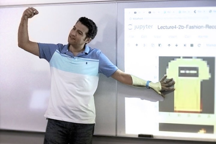 faculty stands in projector light teaching in class