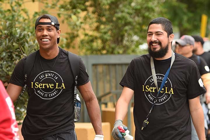 Two male students walking with I Serve L.A. t-shirts