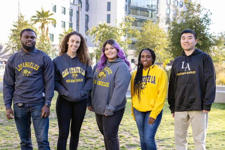 A diverse group of students pose for a photo.