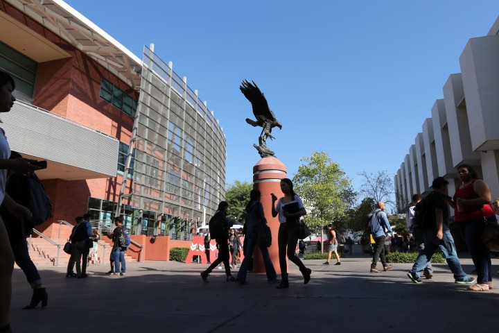 Photo of students walking by the Golden Eagle statue