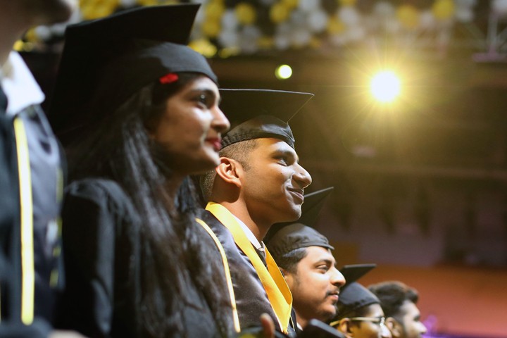 students at commencement in regalia 