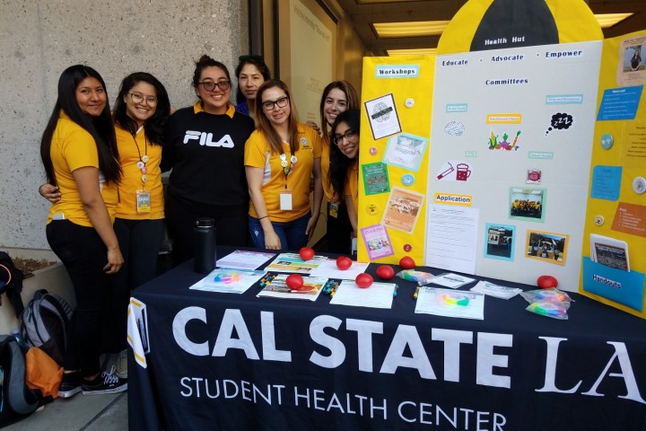 Students at a table showing a research project