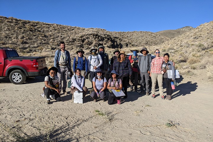 Group of 14 students standing in the desert.