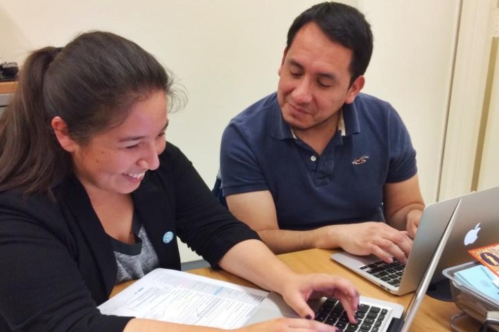 Thesis Reviewer working with student on computer