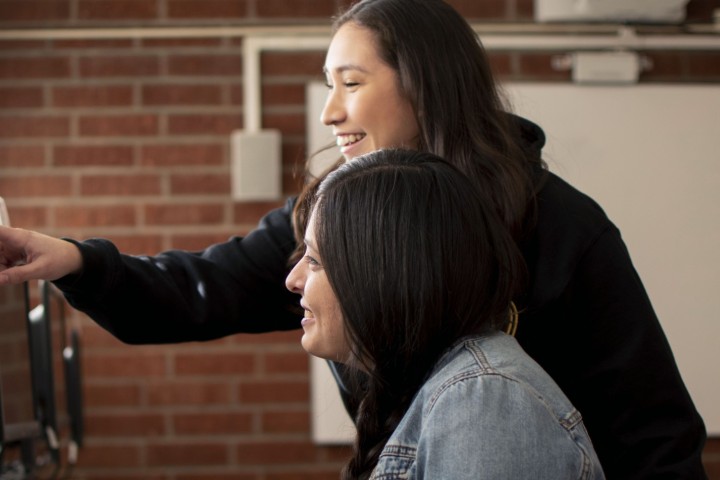 Two students looking at a computer.