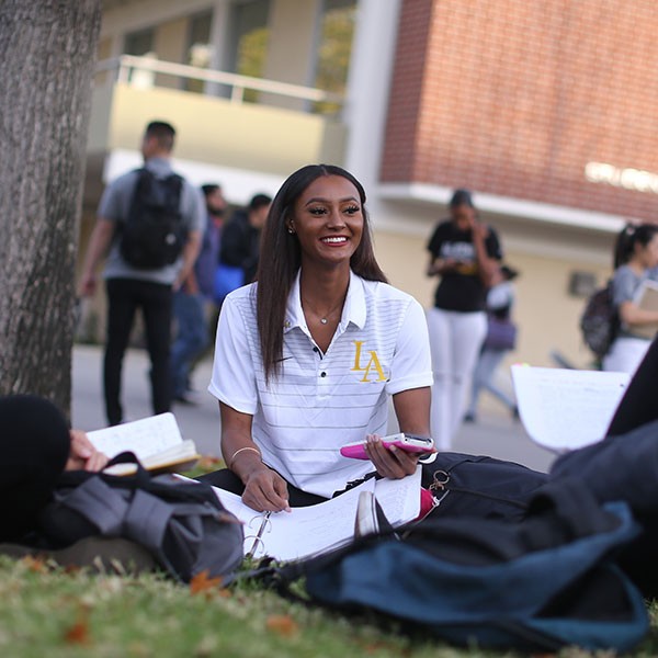 Student sitting on lawn
