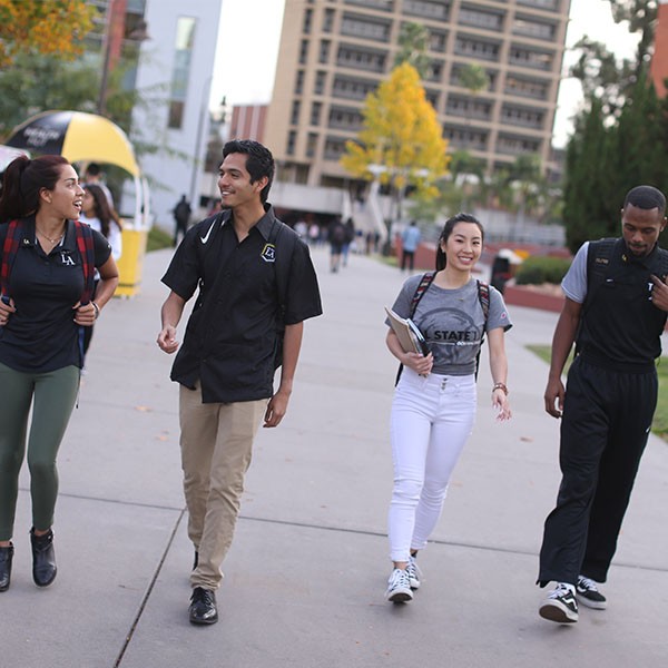 Four students walking on campus