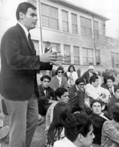 Man standing in a crowd speaking