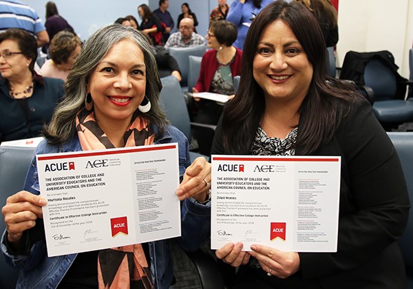 two faculty members showing their certificates after participating in CETL Workshop