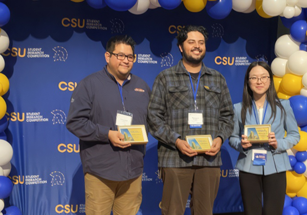 Three students hold plaque at CSU student research competition