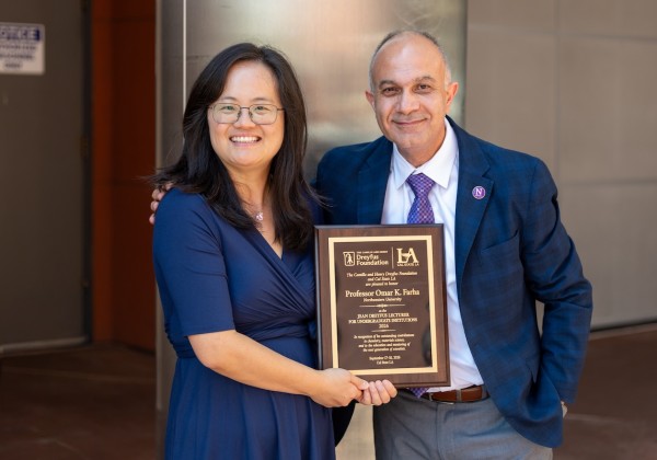 Northwestern University professor Omar K. Farha (right) and Cal State LA chemistry faculty member Yangyang Liu (left) smile while holding a commemorative plaque recognizing Farha's participation in the 2026 Jean Dreyfus Lectureship at Cal State LA.